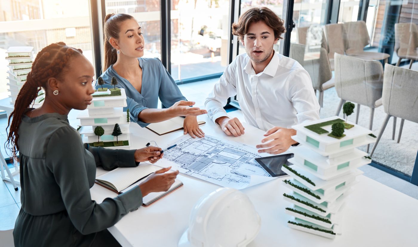 Real estate professionals discussing sustainable building plans